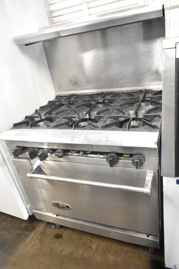 CRC commercial gas range, 6 burners, oven, over shelf, backsplash. Stainless steel, used condition, visible logo on oven door.