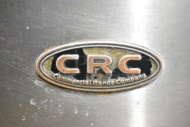 CRC Commercial Range Company logo on a stainless steel surface, slightly worn, indicating a gas-powered 6-burner range.