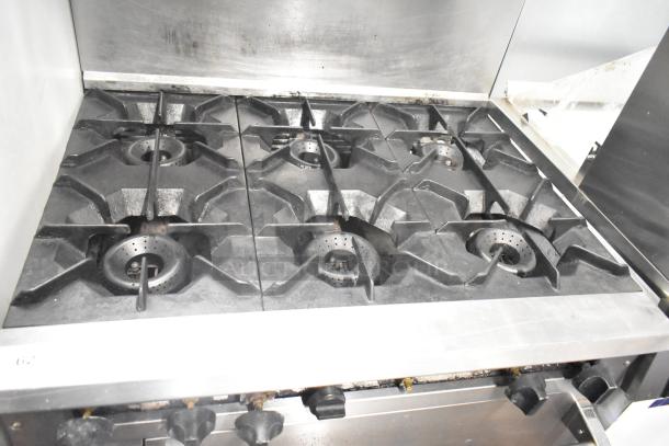 CRC Commercial Gas 6 Burner Range with oven, over shelf, and backsplash. Used condition, sturdy cast iron burners.