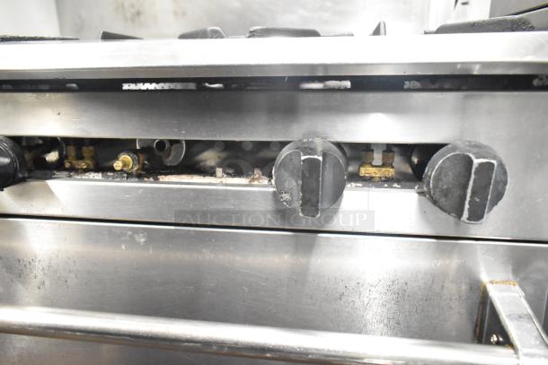 CRC Commercial Gas 6-burner range with oven, over shelf, and back splash. Visible wear on knobs and surface.
