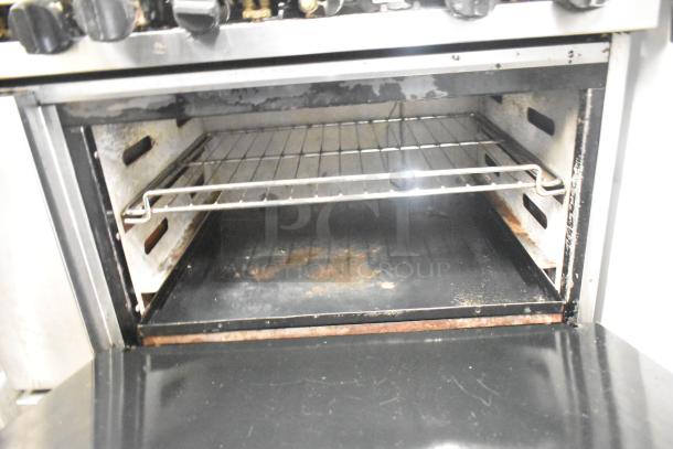 CRC Commercial Gas 6 Burner Range with oven, over shelf, and backsplash. Visible wear inside the oven.