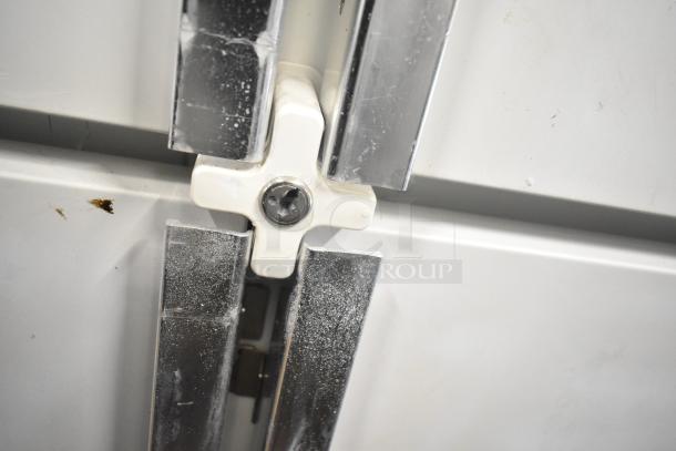 Kelvinator T5CHSGHP-4 commercial refrigerator door detail; shows hinge and slight wear. Model T5CHSGHP-4, 115/208-230V.