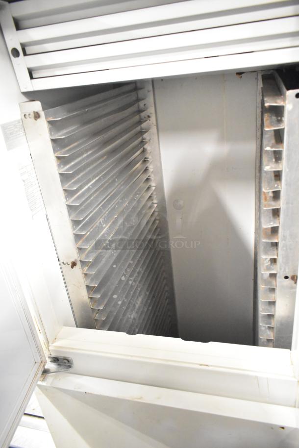 Kelvinator T5CHSGHP-4 commercial reach-in cooler, four half-size doors, visible stainless interior, 115/208-230V, 1 phase.