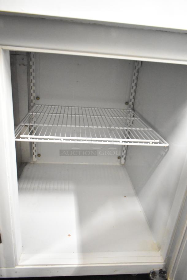 Kelvinator T5CHSGHP-4 commercial reach-in with 4 half-size doors, features adjustable shelving. 115/208-230V, 1 Phase.