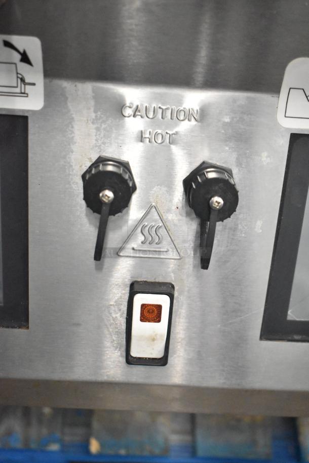 Commercial electric griddle with 3-section panini clam shell, control knobs, and "Caution Hot" label indicating high heat.