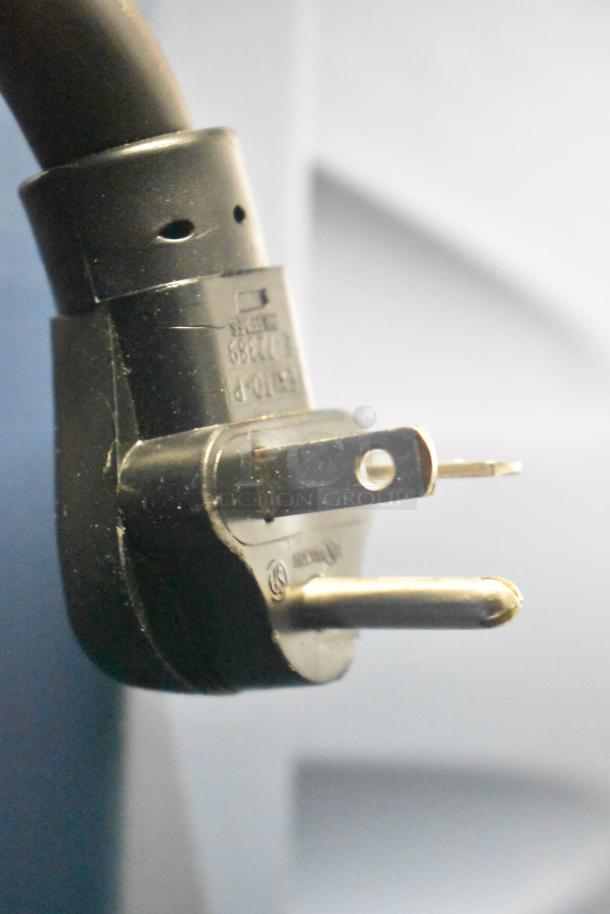 Close-up of a three-pronged power plug for the 2020 Metro C5 3 Series Heated Holding Cabinet, showing voltage and markings.
