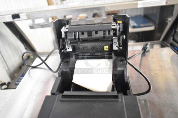 Star TSP100II countertop receipt printer showing open paper roll compartment, power cable attached. Good condition.