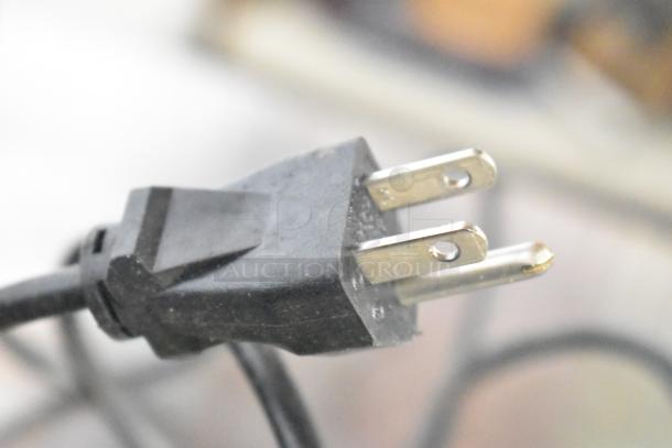 Power plug for a Star TSP100II Countertop Receipt Printer, close-up view.