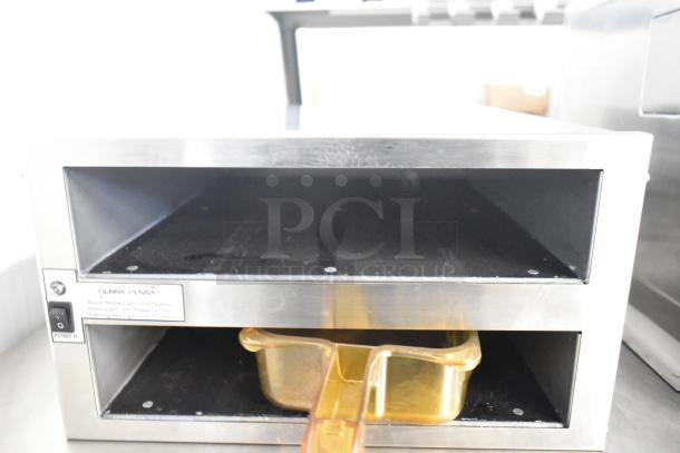 Henny Penny MPC-22 holding bin, stainless steel, 2 shelves, 4-pan capacity, visible power switch, site label, 120V, 1 phase.