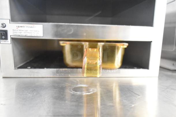 Henny Penny MPC-22 countertop two-shelf holding bin with gold pan. Features 120 volts, 1 phase. Visible Henny Penny label.