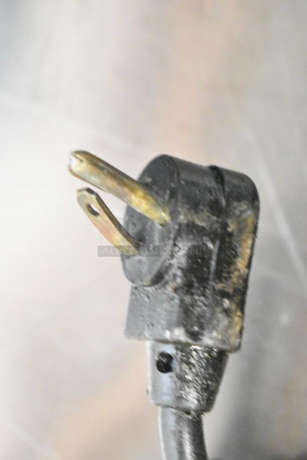 Close-up image of a power plug for a True TRCB-52-60 commercial chef base, showing signs of wear.