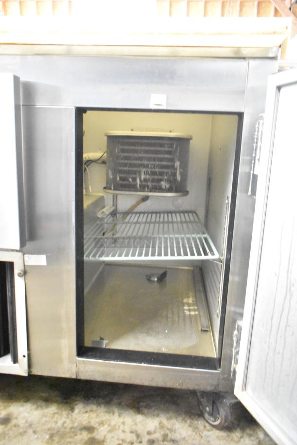 Leader LM36 S/C 2-door undercounter cooler, stainless steel, open door view, showing interior shelves and cooling mechanism.