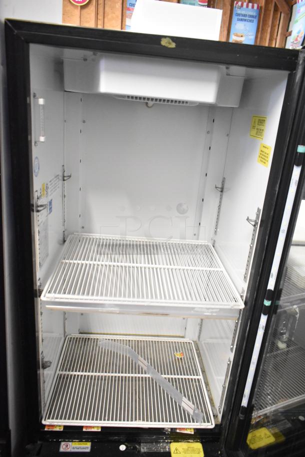 Imbera VR10 commercial single door reach-in cooler merchandiser, 115 volts, 1 phase, features adjustable shelves, visible interior markings indicating safety warnings and voltage.