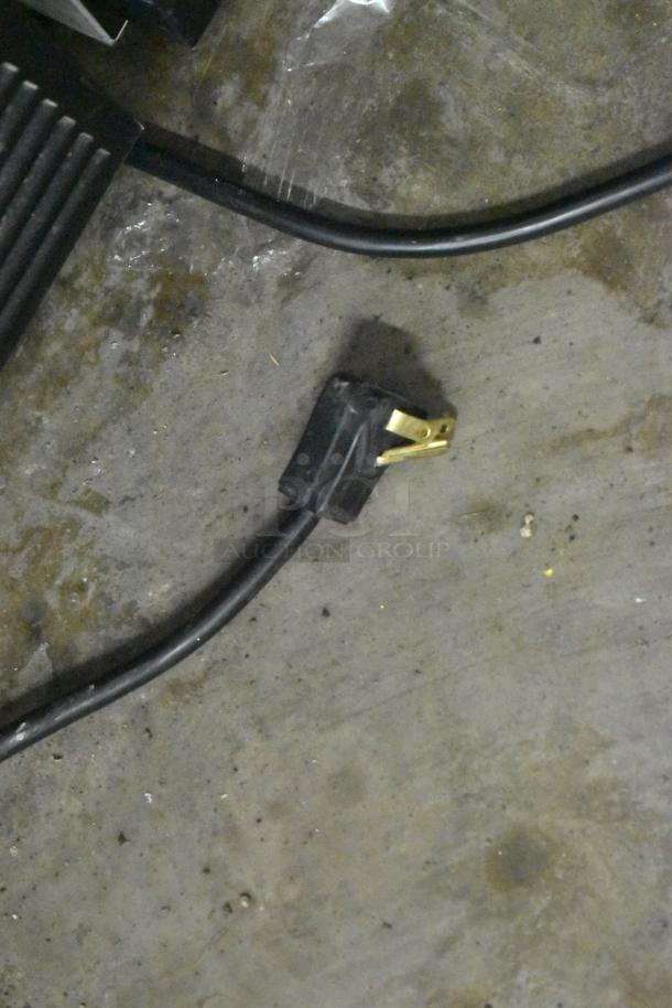 A power cord on the floor, possibly from the 2019 Habco SE18 Commercial Cooler, showing the plug end detail.