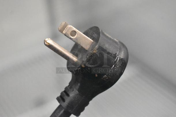 Close-up of a three-prong power plug for a 2022 True T-19F-HC commercial freezer, 115 volts, 1 phase.