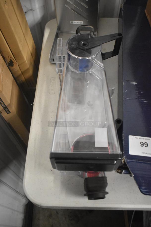 Clear Server countertop dry dispenser with black handle, in good condition. Features a visible measuring scale on the side.