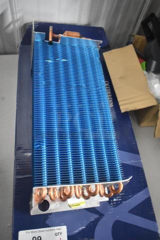 BRAND NEW! Norpole 4R7K370L evaporator coil with minor scratches. Blue fins, copper tubing, visible label, in packaging.