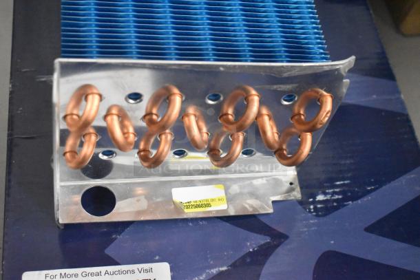 Brand new Norpole 4R7K370L evaporator coil with visible copper pipes and blue fins; minor scratch and dent.