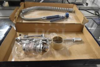 Brand new Waterloo 750PRD4X pre-rinse faucet, 1.15 GPM, deck-mounted, 4" centers, minor scratches, in original packaging.