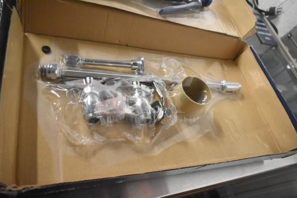 Brand new Waterloo 750PRD4X 1.15 GPM deck-mounted pre-rinse faucet with 4" centers in original packaging, minor scratches.