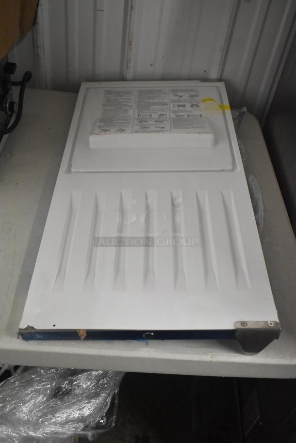BRAND NEW Hoshizaki ice machine door with minor scratches and dents. White panel with instructions label on surface.