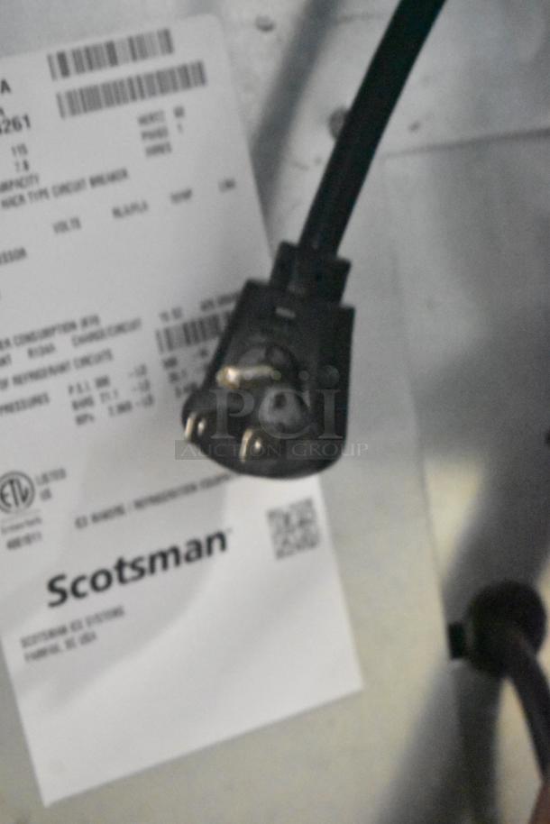 2024 Scotsman UC2024SA-1A undercounter ice machine, stainless steel, 227 lb capacity, 115V, 1 phase, label and plug shown.