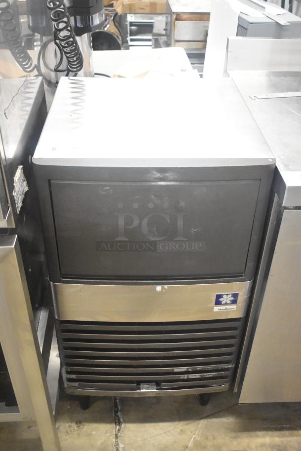 Manitowoc QM45A stainless steel undercounter ice machine, shows moderate use, 115V, 1 phase, front logo visible.