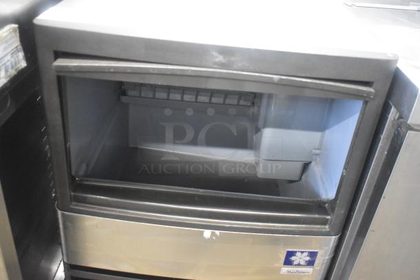 Manitowoc QM45A stainless steel undercounter ice machine, self-contained, 115 volts, used. Visible logo and model mark.