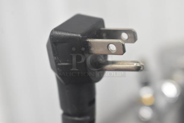 Close-up of a black three-prong plug for Continental KC24-SS Kegerator, showing standard electrical connection.