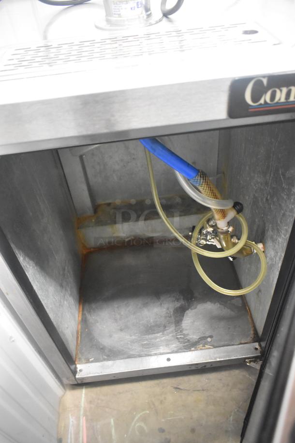 Continental KC24-SS kegerator interior with visible hoses, commercial grade, used condition, rust present. Model label intact.