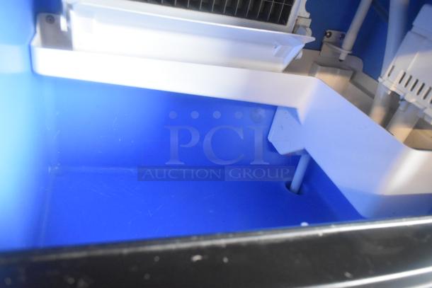 2023 Coldline ICE80-HA undercounter ice machine interior, showing blue compartment and white components, excellent condition.