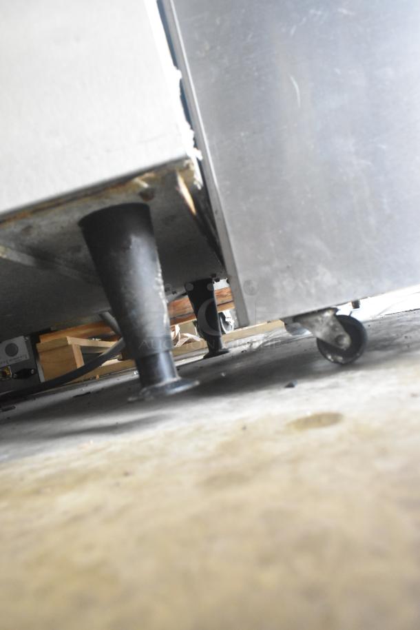 Ice-O-Matic ICE0400FW4 stainless steel ice machine with B40PSB bin, 115V, 1 phase, viewed from ground level, showing legs.