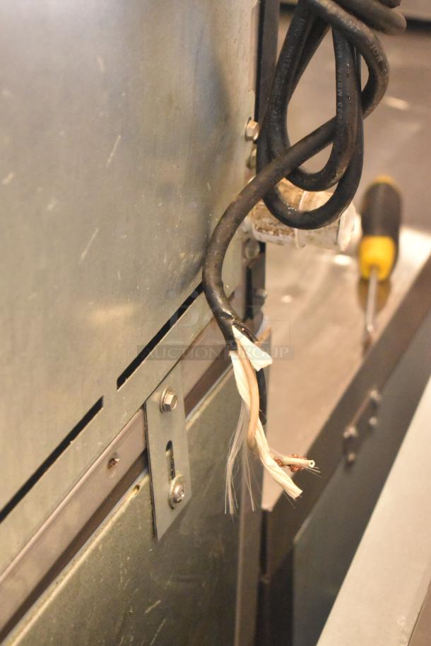 Stainless steel Ice-O-Matic ICE0400FW4 ice machine with B40PSB bin. 115V, 1-phase. Exposed wires seen on back.