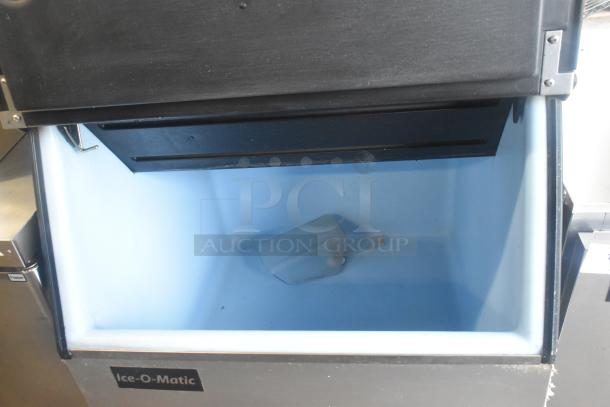 Ice-O-Matic ICE0400FW4 stainless steel commercial ice machine head on B40PSB bin, 115V, 1 phase, open lid view.