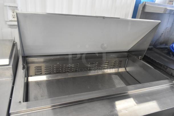 Avantco 178SSPT48MHC stainless steel commercial sandwich salad prep table. Features a mega top and commercial casters.
