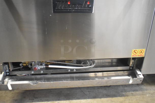 Migali C-RO4B-12GL-NG commercial range with 4 burners, griddle, and oven, on casters. Features brand logo and safety labels.