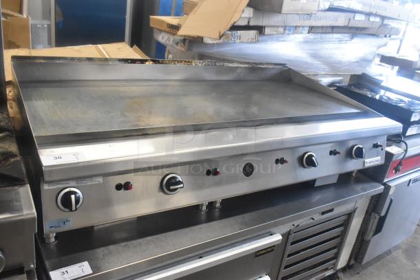 Garland GTGG60 commercial countertop natural gas griddle, stainless steel, multiple control knobs, used condition, visible label.