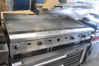 Garland GTGG60 commercial countertop natural gas griddle, stainless steel, multiple control knobs, used condition, visible label.