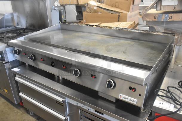 Garland GTGG60 Commercial Flat Top Griddle, natural gas, stainless steel, four control knobs, used condition, logo visible.