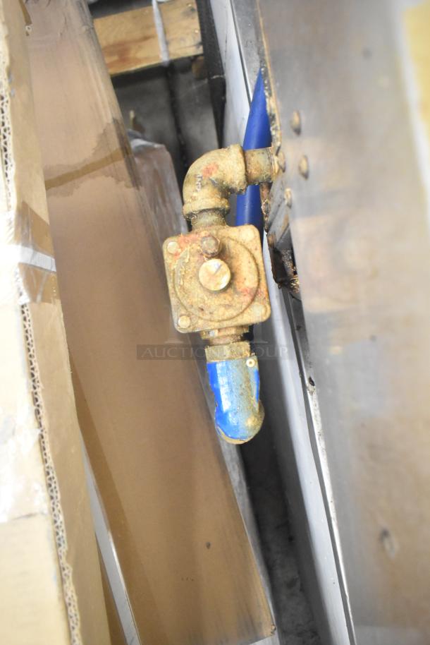 Close-up of a rusted gas connection on a Garland GTGG60 commercial griddle.