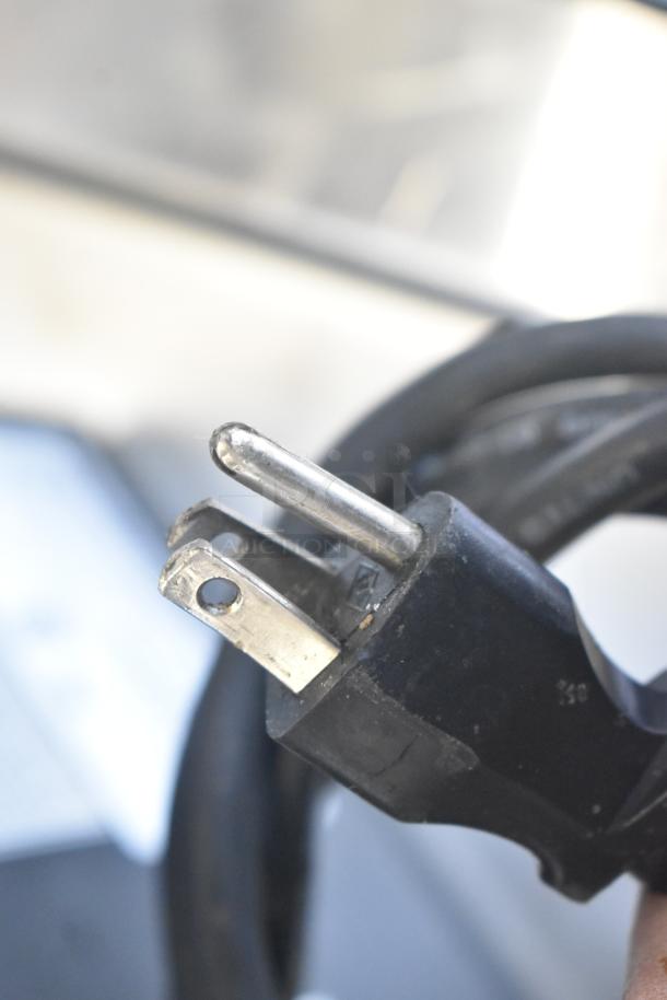 Close-up of a 2016 Bunn LCA-1 coffee dispenser power cord plug, showing standard 120V, 1-phase US plug.