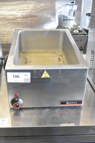 Adcraft FW-1500W/C Countertop Food Warmer in stainless steel, features dial control and caution label. 120V, 1 Phase. Auction tag visible.
