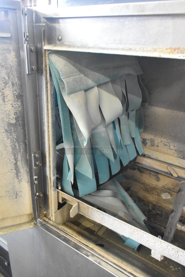 Champion commercial conveyor dishwasher, 208V, 3-phase. Visible signs of wear, interior view with hanging elements.