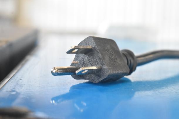 Close-up of a black electrical plug, compatible with the A-11 Commercial Single Door Reach In Cooler Merchandiser, 115 Volts.