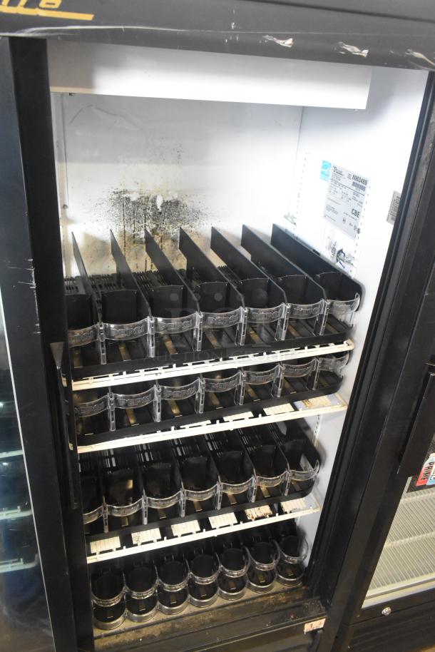 True GDM-41SL-60-LD commercial cooler, dual doors, shelving for beverages, visible interior wear, 115V, 1 phase.