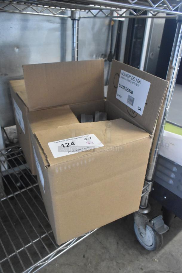 Cardboard box labeled "NUMBER DELI BK" with model 512XKD590B. Contains deli tag inserts and blank name inserts. New condition.