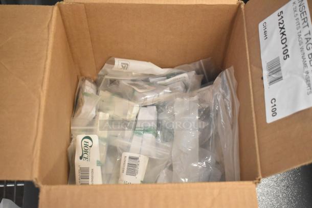 Box containing new scratch and dent deli tag inserts, including Choice UXKD59008079 letters, 512XKD590B numbers, and 512XKD105 blank name inserts.