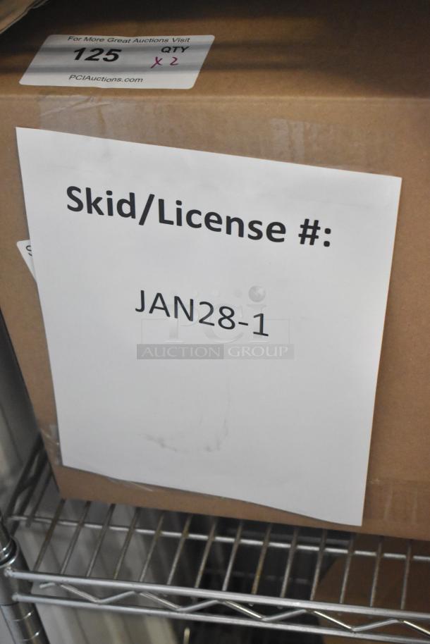 Box labeled "JAN28-1" with auction sticker "QTY 2", containing scratch and dent deli tags including 512XKD710BK and others.
