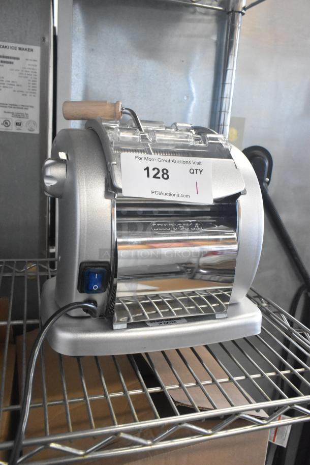 Brand new Imperia NSP countertop pasta machine with minor scratches, featuring a silver finish, power switch, and tag indicating "128 QTY".