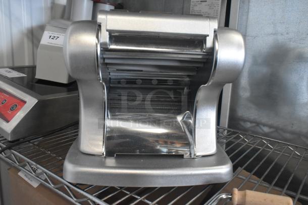 BRAND NEW Imperia NSP countertop pasta machine, stainless steel, with minor dents, sits on a metal shelf.